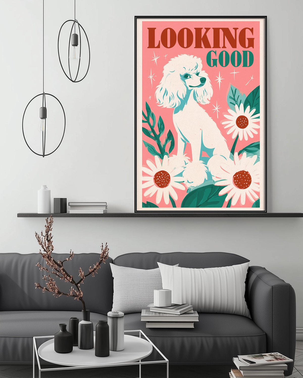 a living room with a gray couch, a coffee table, and a framed poster of a poodle with flowers on the wall above it.