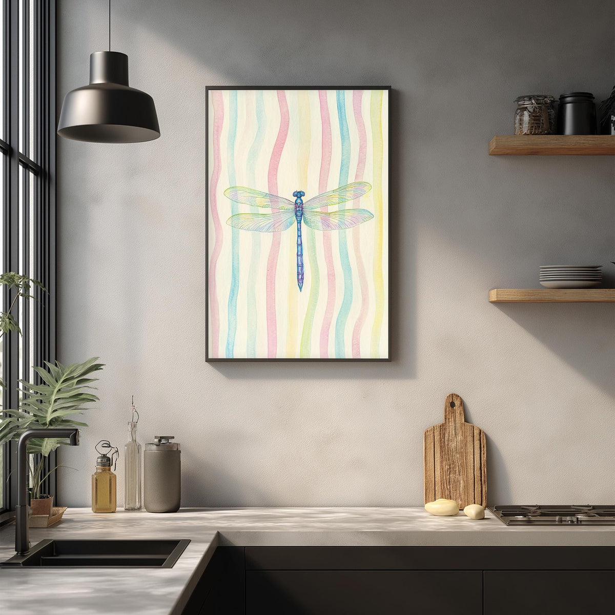 a kitchen counter with a framed picture of a dragonfly hanging above it. The counter has various kitchen items, such as a cutting board, a bottle, and a vase. The kitchen has a modern design with a gray wall and a pendant light hanging above the counter.