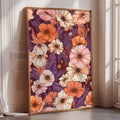 a large, framed print of a vibrant floral pattern in shades of orange, pink, and white, displayed on a wall in a room with a window.