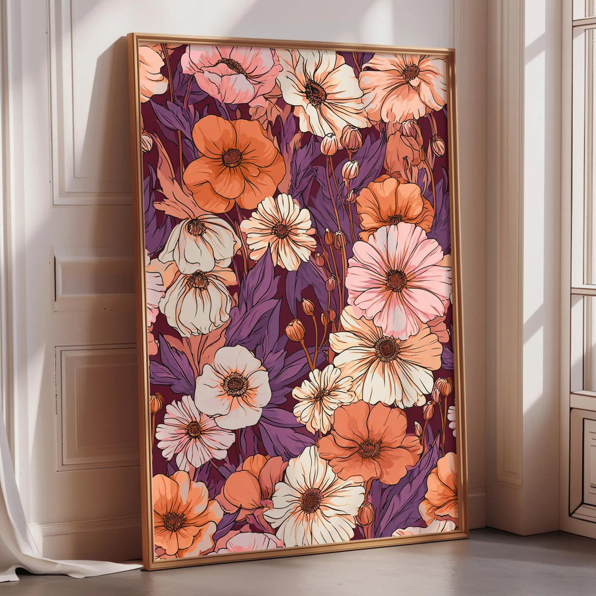 a large, framed print of a vibrant floral pattern in shades of orange, pink, and white, displayed on a wall in a room with a window.