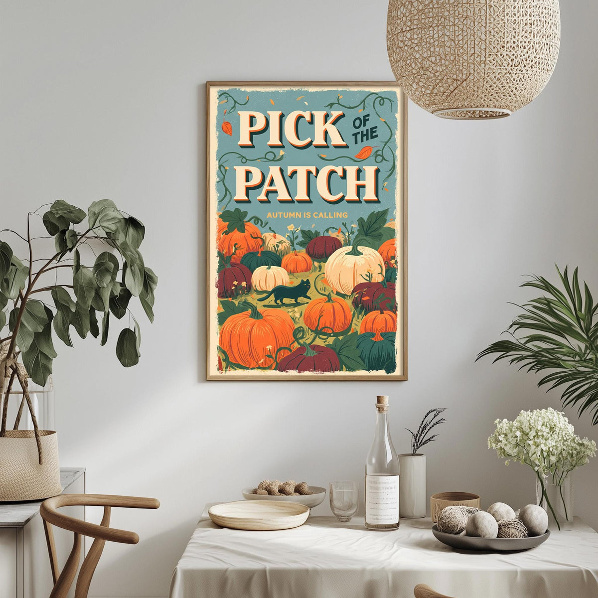 a framed poster of a pumpkin patch hanging on a wall, with a dining table and chairs in the foreground.