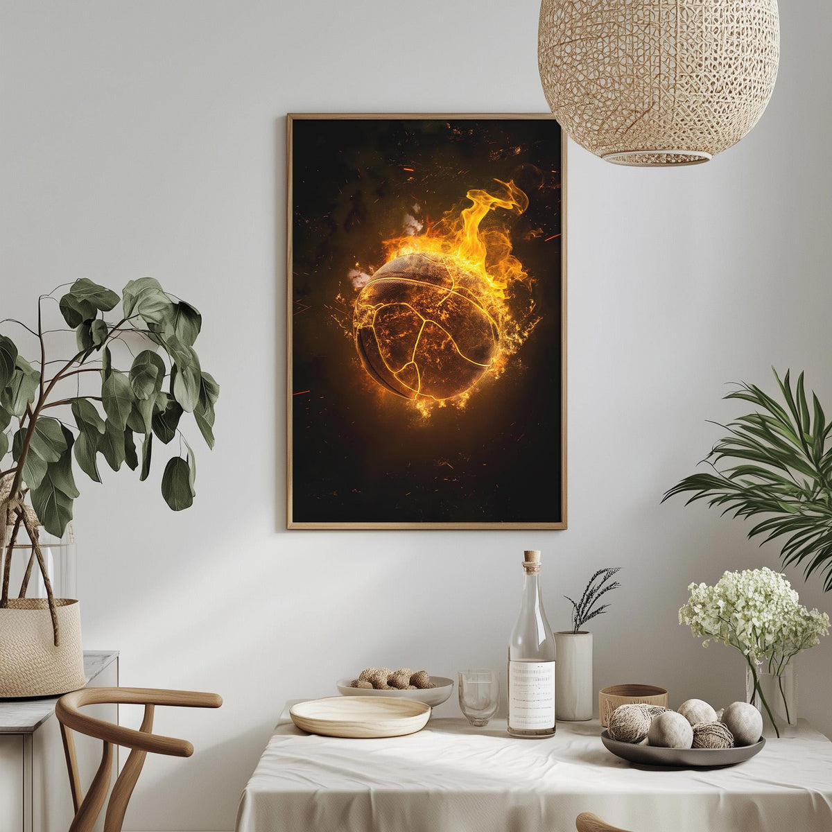 a framed artwork depicting a fiery ball or globe, hanging on a wall above a dining table with various decorative items and plants.