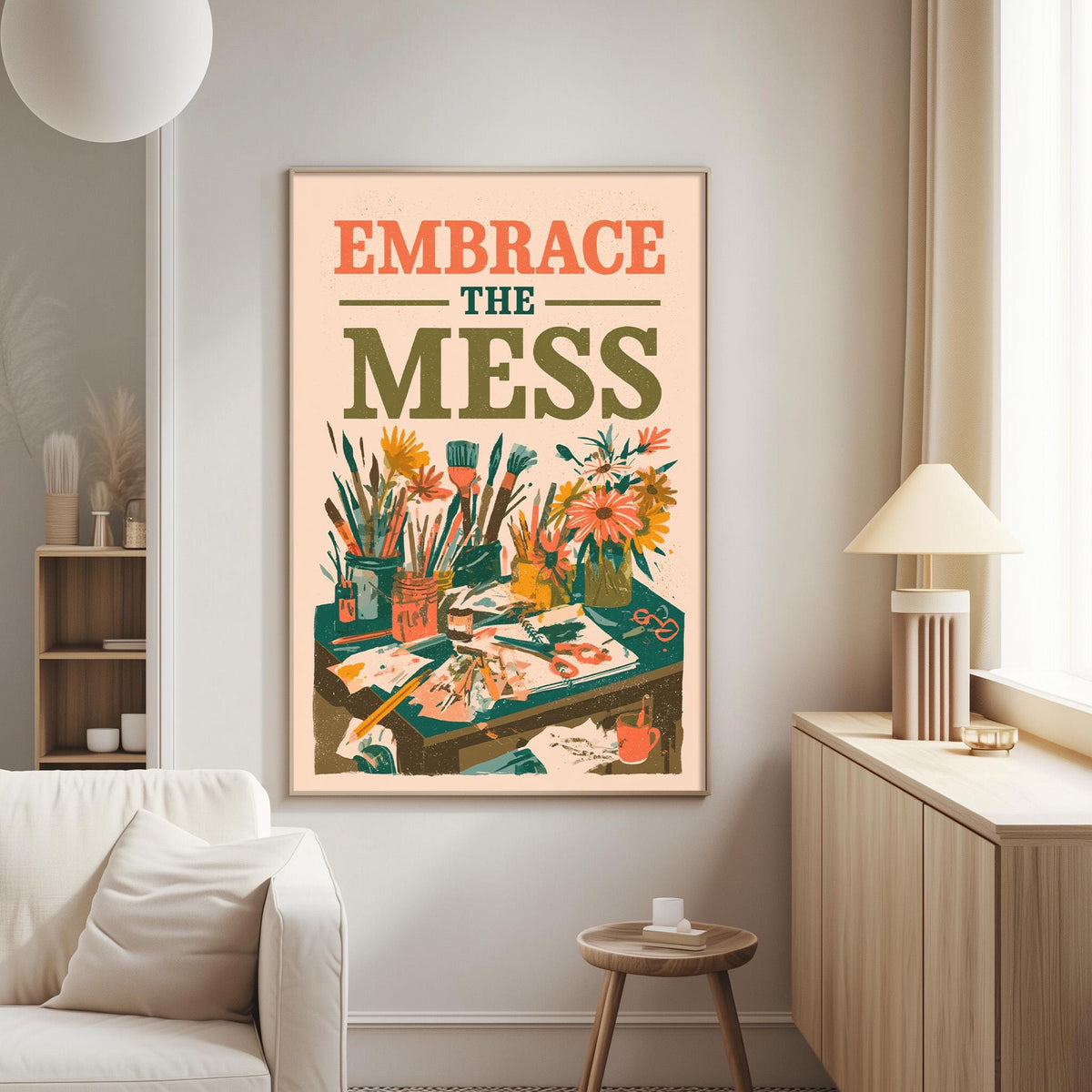 a poster with the text "Embrace the mess" and an illustration of a cluttered desk with various objects, such as a lamp, vase, and books.
