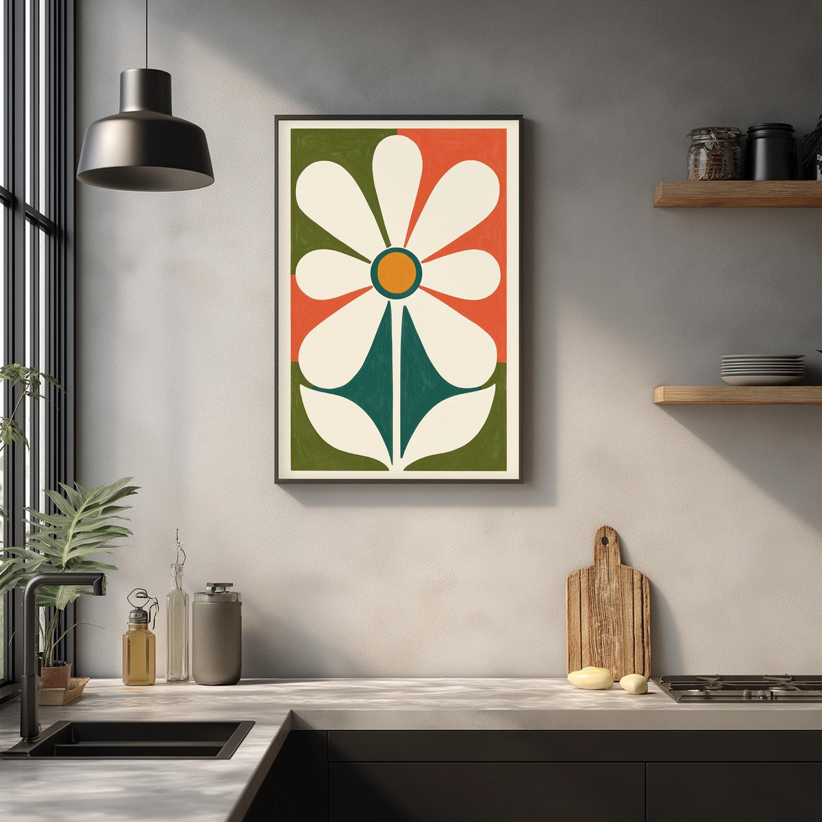 a kitchen counter with a framed abstract flower design hanging on the wall above it. The counter has various kitchen items, such as a cutting board, a knife, and a bottle, as well as a potted plant.