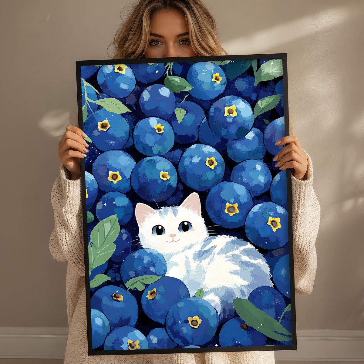 A woman holds up a framed print featuring a white cat surrounded by a large number of blueberries.