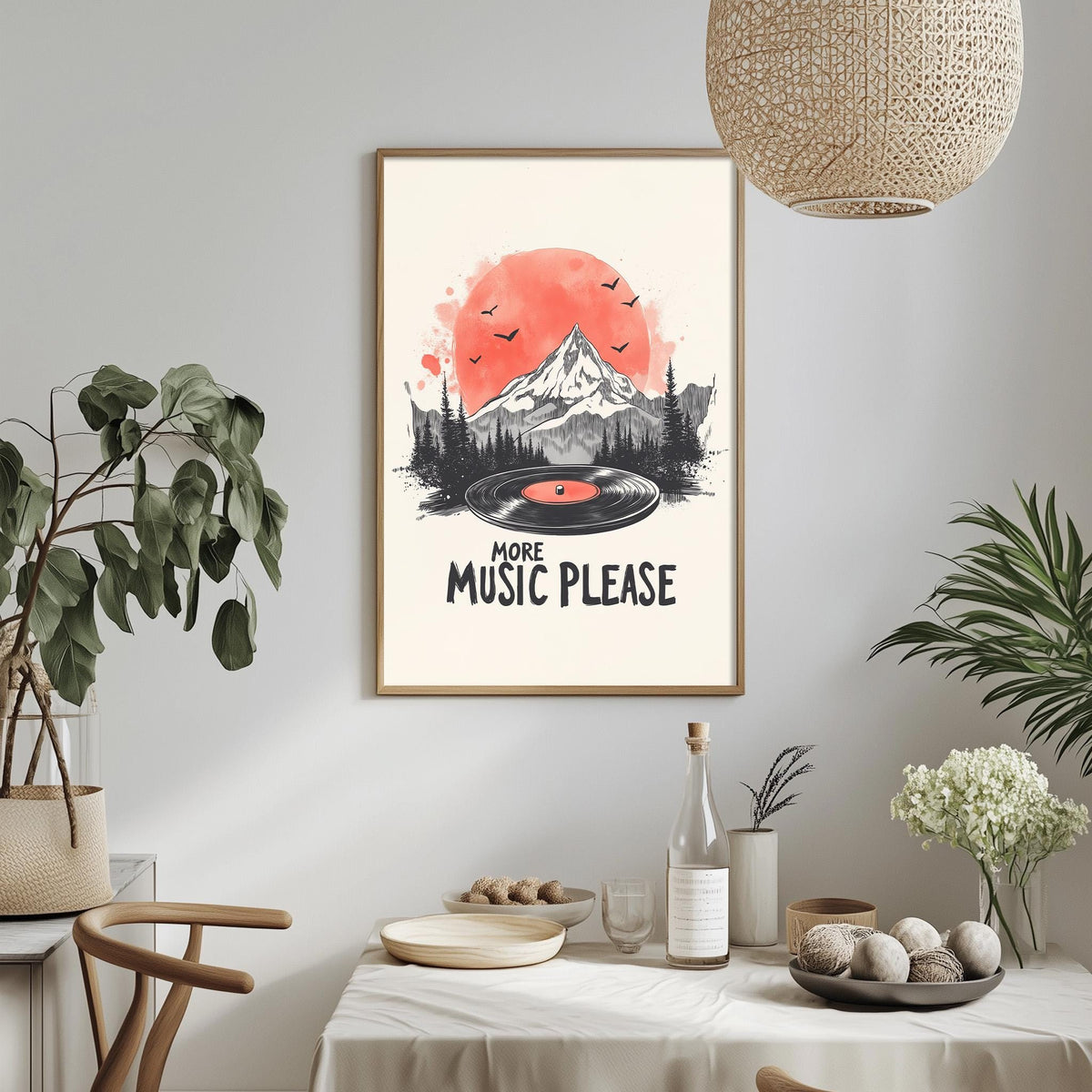 a framed poster with a mountain landscape and a record player, along with the text "MORE MUSIC PLEASE" displayed on the poster. The poster is hanging on a wall, and there is a dining table with various items on it, including a bottle, a bowl, and a vase.