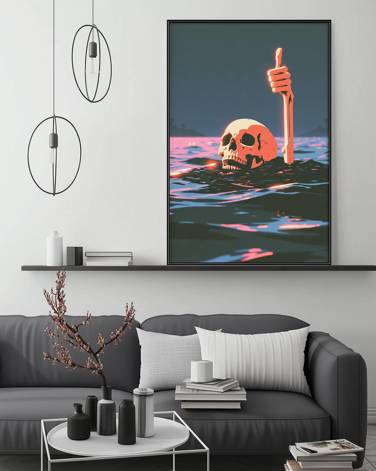 a large framed artwork depicting a skull submerged in water, with a hand giving a thumbs-up gesture above it. The artwork is displayed on a wall above a gray couch in a living room setting.