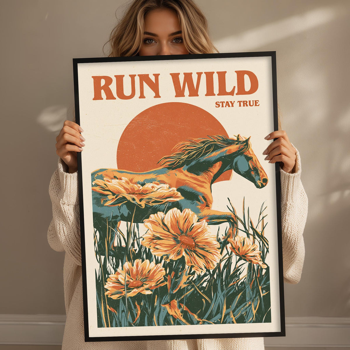 A woman holding a framed poster with an illustration of a horse and flowers.