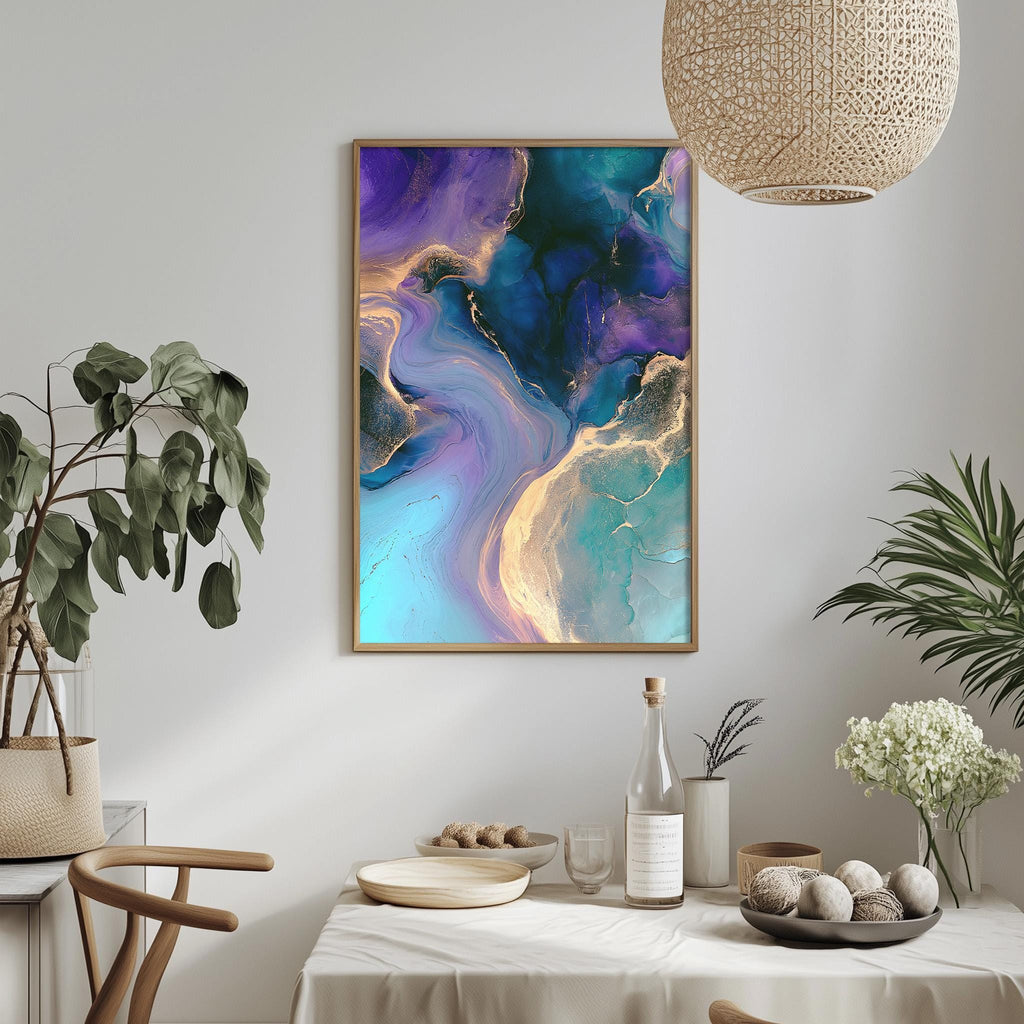 a dining table with a white tablecloth, a bowl of fruit, a bottle, and a vase with flowers. Above the table, there is a framed abstract painting with a vibrant color palette of blue, purple, and yellow.
