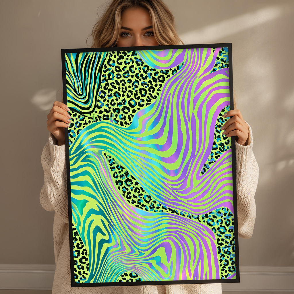A woman is holding up a framed poster with a vibrant, abstract design featuring a mix of green, yellow, and purple colors, along with leopard print elements.