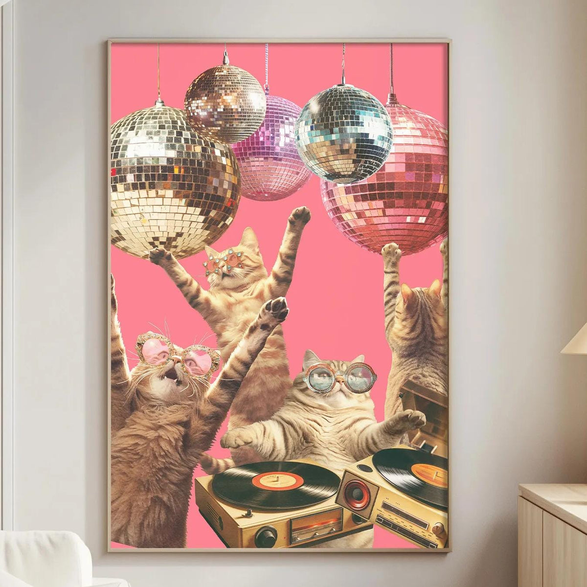 A collage of cats dancing and playing with disco balls in a pink background, with a record player and a lamp in the foreground.