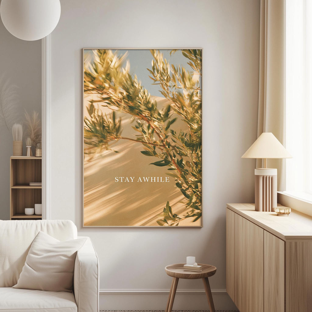 a living room with a large framed picture of a tree branch with green leaves and the text "STAY AWAY" on the wall.