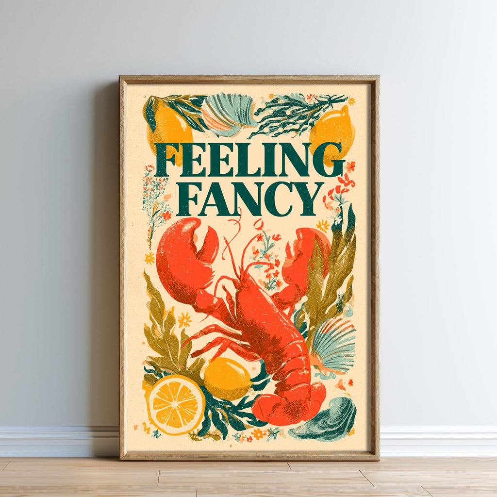 The image is a framed poster featuring an illustration of a lobster surrounded by various fruits and vegetables, with the text "Feeling Fancy" prominently displayed.