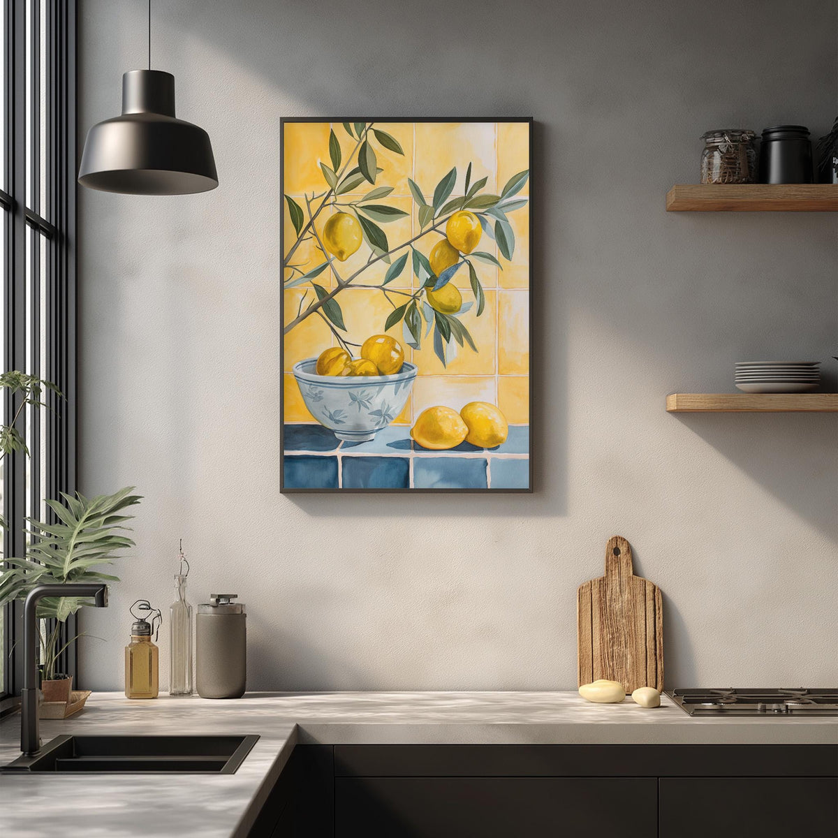 a kitchen counter with a framed painting of lemons hanging on the wall above it. The painting depicts a bowl filled with lemons, and there are additional lemons on the counter. The kitchen also includes a sink, a wooden cutting board, and some decorative items on the counter.