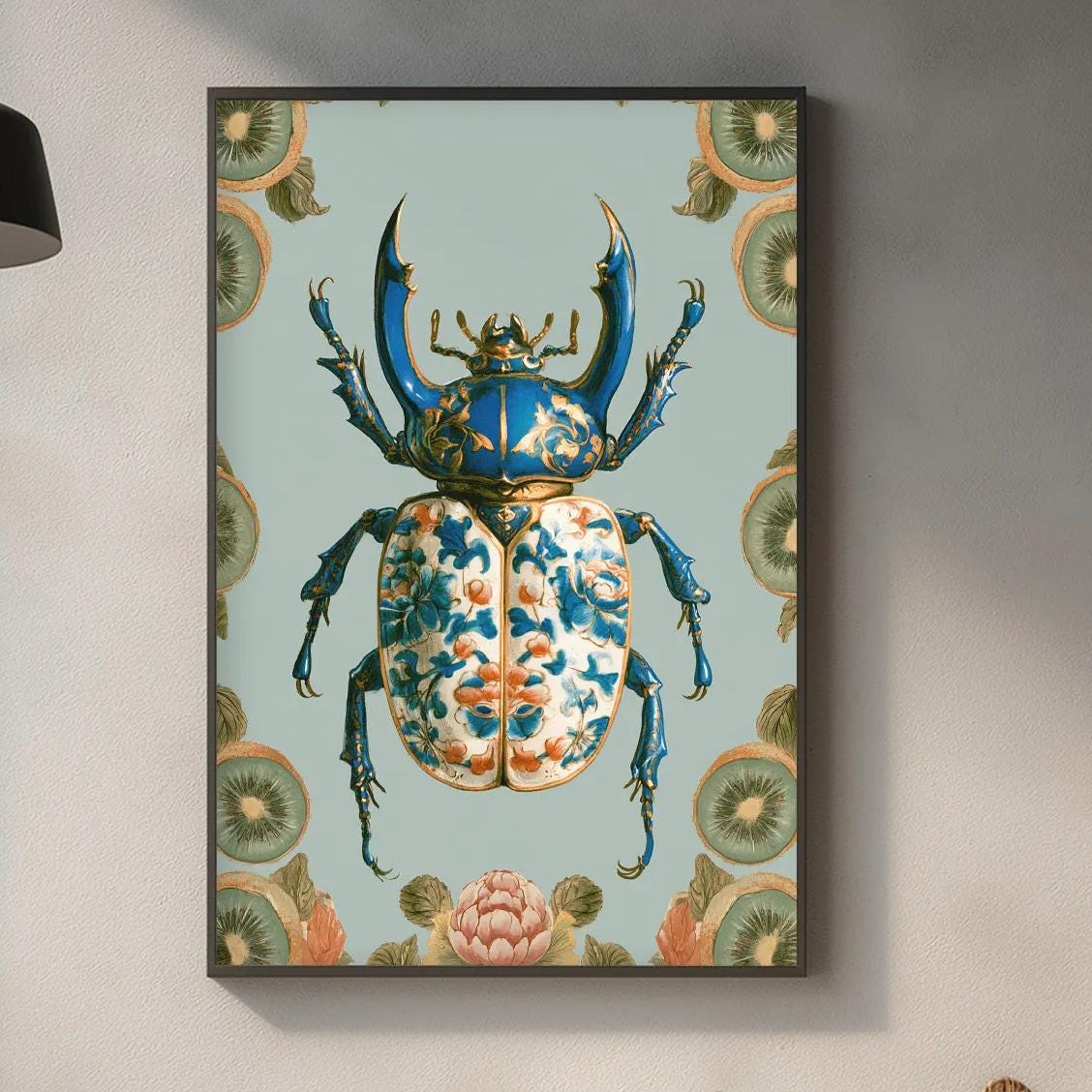 a kitchen counter with a framed picture of a colorful beetle hanging on the wall above it. The counter also has various kitchen items such as a cutting board, a bottle, and a bowl.