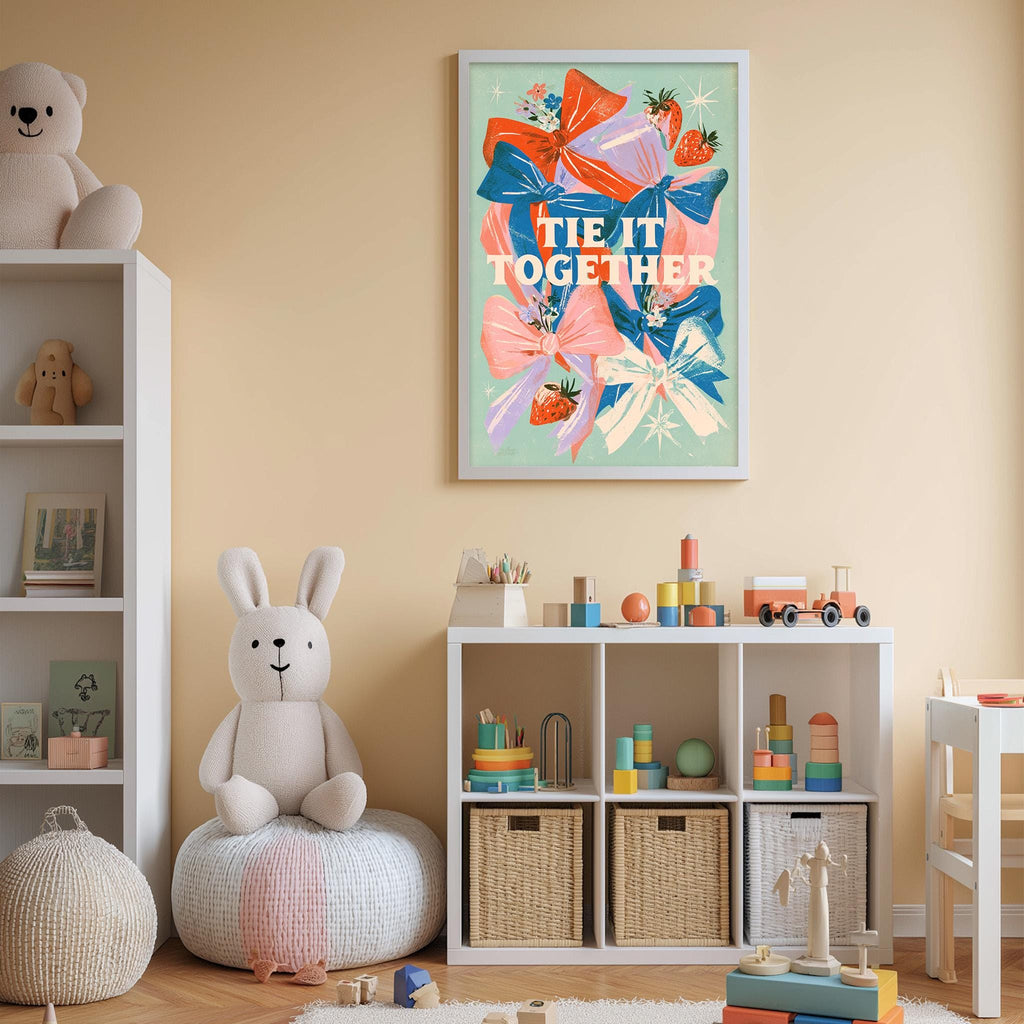 A child's bedroom with a white bookshelf, a stuffed rabbit, and a colorful poster on the wall. The poster features a playful design with bows and flowers, and the text "tie it together" is written in a whimsical font.