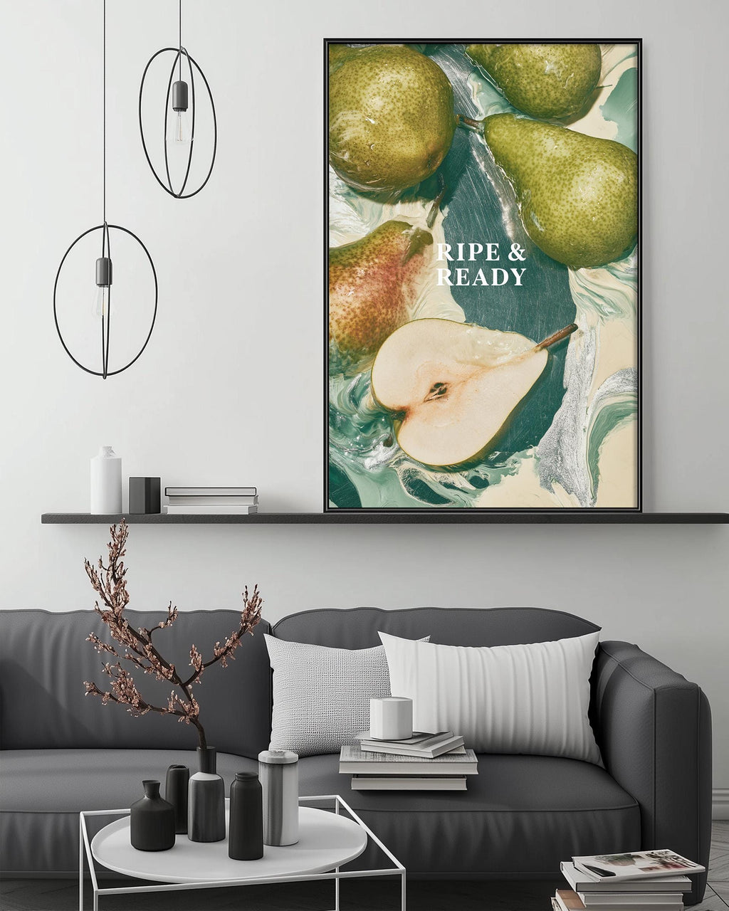 a modern living room with a gray sofa, a coffee table, and a large framed poster of pears hanging on the wall.