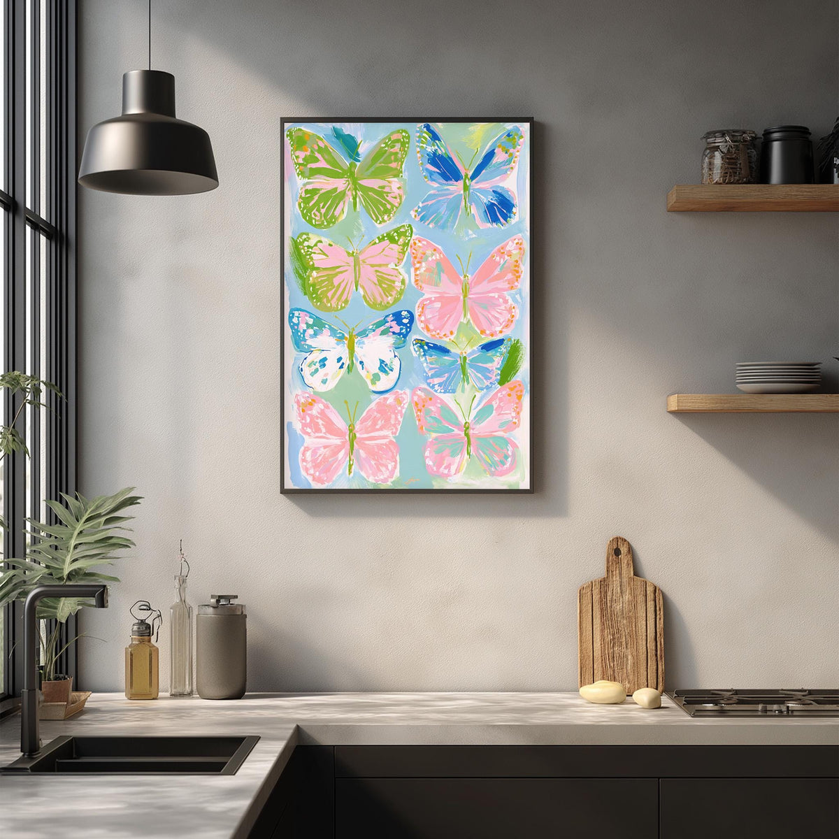 a kitchen counter with a framed painting of colorful butterflies hanging above it. The painting is a vibrant display of various butterfly species, including green, pink, and blue ones, creating a lively and cheerful atmosphere in the kitchen.