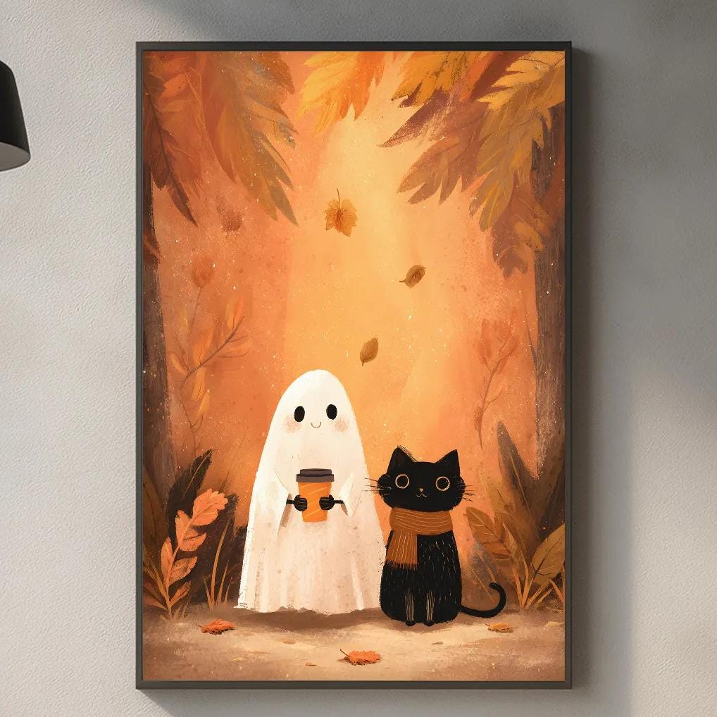 a kitchen scene with a framed illustration of a ghost and a cat on the wall.