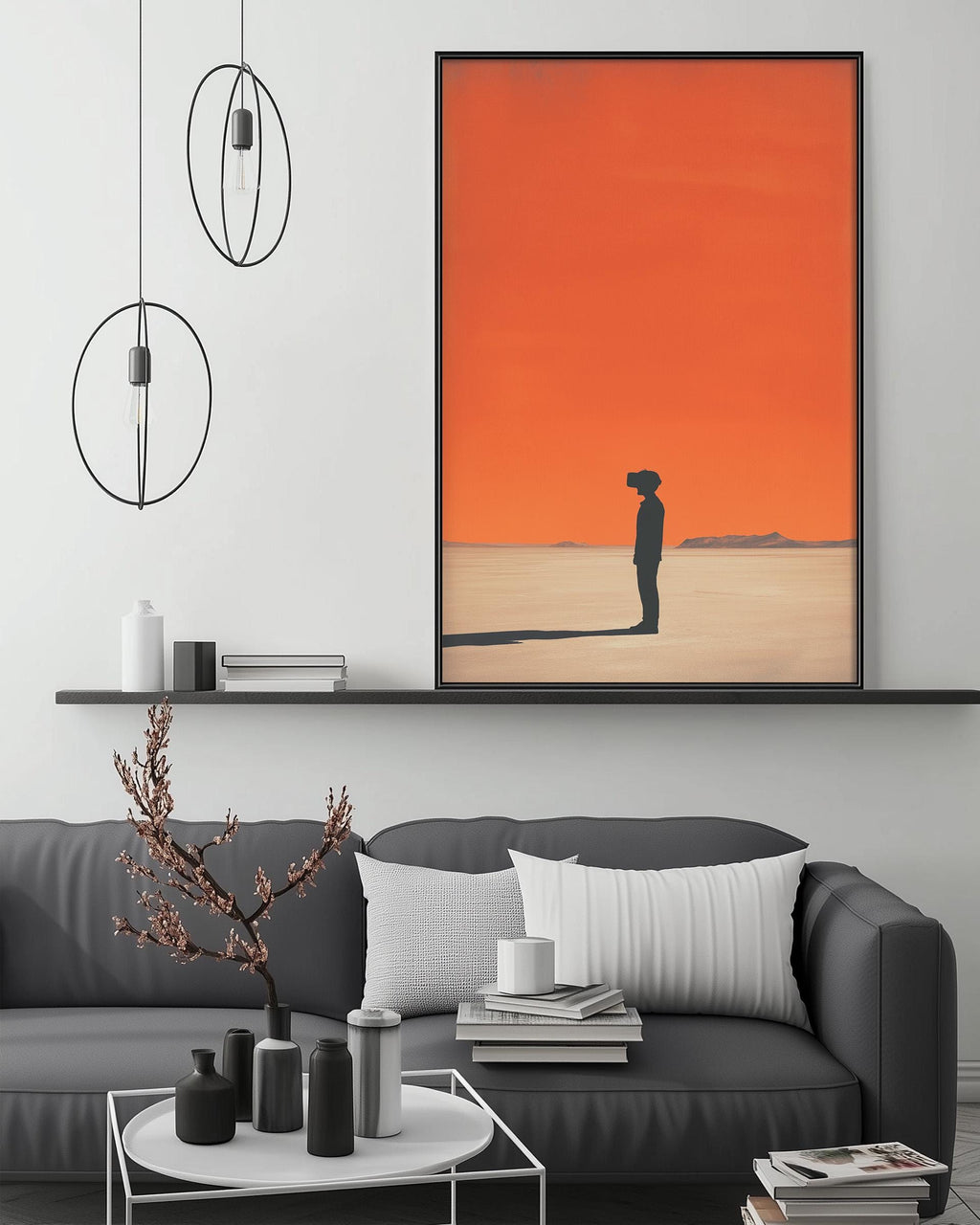 a modern living room with a gray sofa, a coffee table, and a large framed artwork depicting a person standing in a desert landscape with an orange sky.