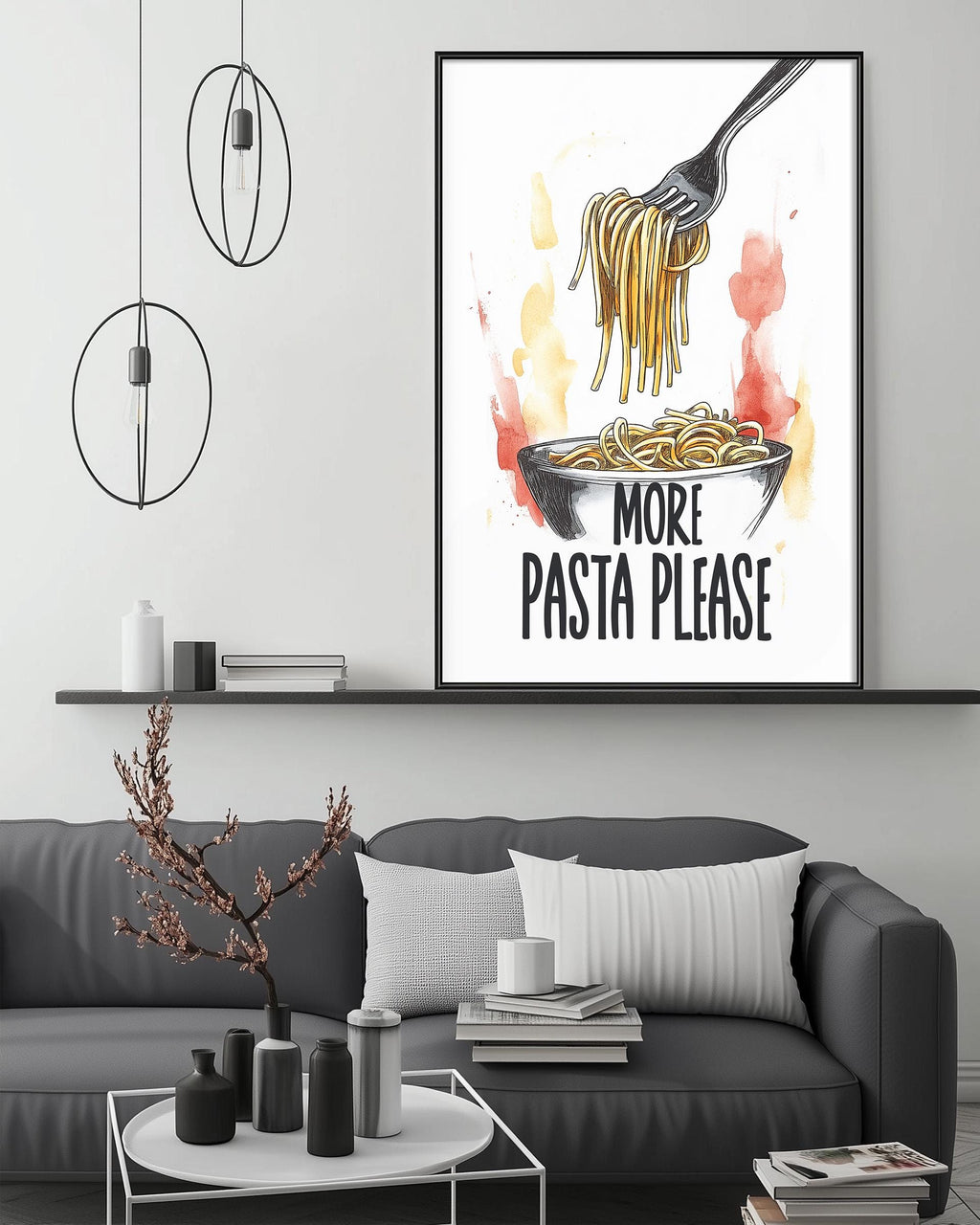 a framed poster with a drawing of spaghetti and a fork, accompanied by the text "MORE PASTA PLEASE" on a wall above a gray couch.