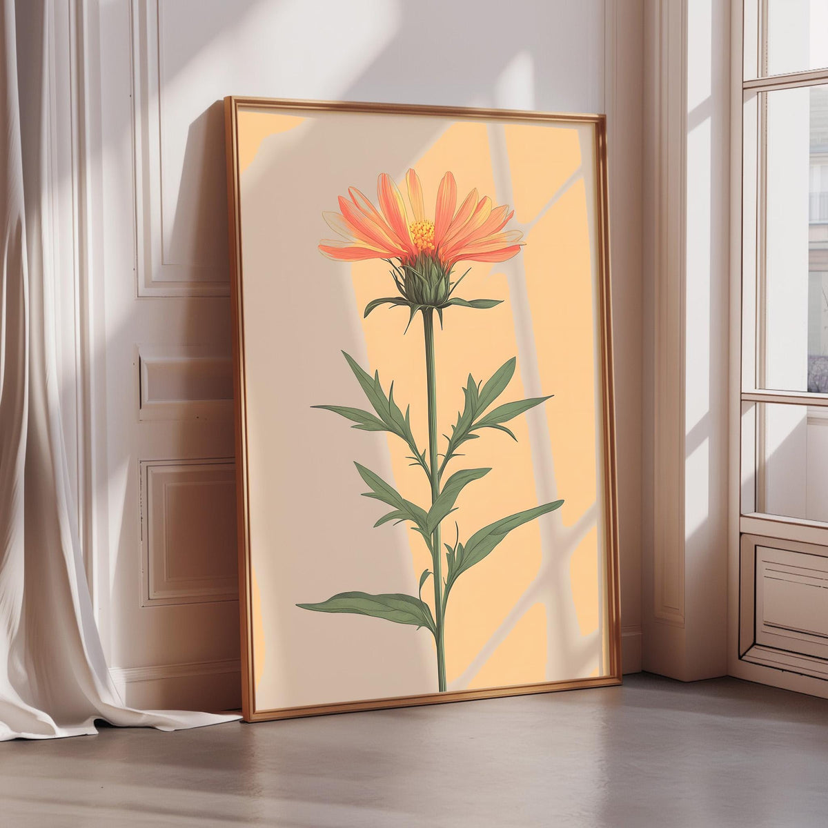 A framed illustration of a vibrant orange flower with green leaves is displayed on a wall in a room with sunlight streaming in from a window.