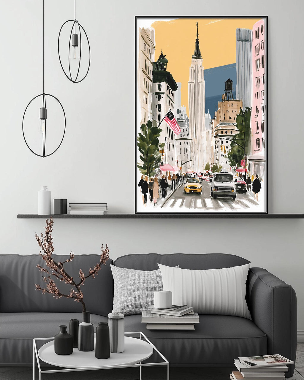 a modern living room with a gray sofa, a coffee table, and a large framed artwork depicting a city street scene with tall buildings, cars, and people.