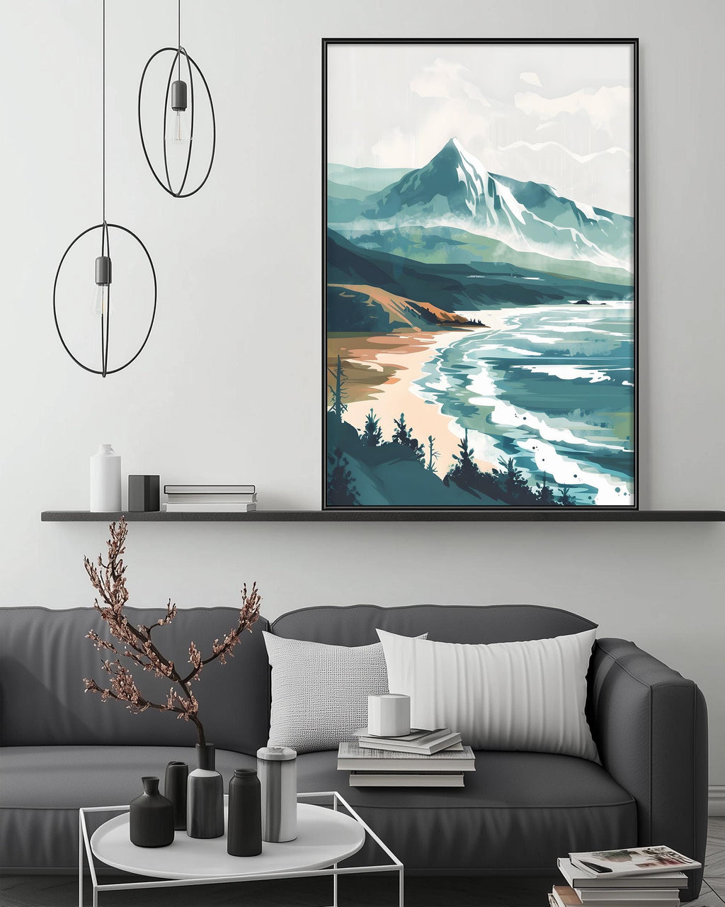 a modern living room with a gray sofa, a coffee table, and a large framed landscape painting depicting a mountain scene with a beach and ocean.