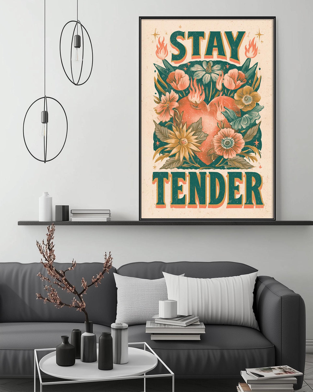 a living room with a gray couch, a coffee table, and a large framed poster with a floral design hanging on the wall.