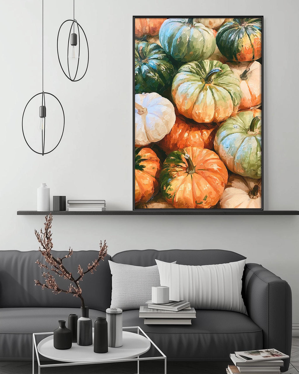 a cozy living room with a gray sofa, a coffee table, and a large framed picture of pumpkins hanging on the wall above the sofa.
