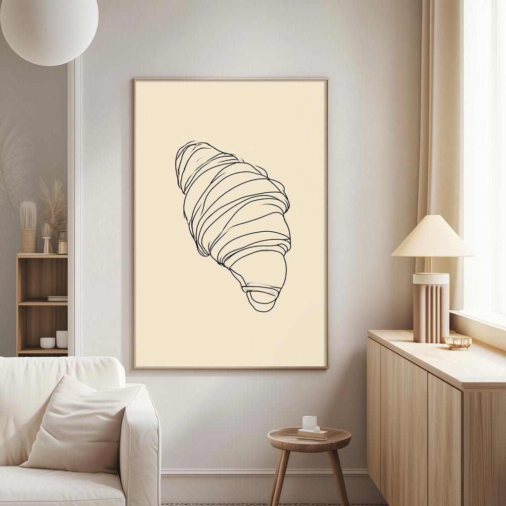a living room with a white sofa, a wooden side table, and a framed drawing of a croissant on the wall.