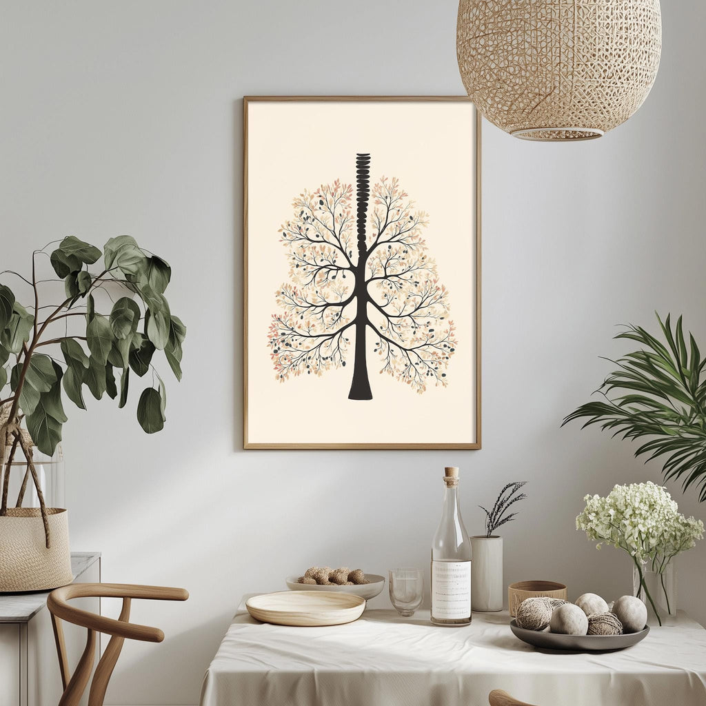 a dining table with a white tablecloth, a bowl of fruit, a bottle, and a vase with flowers. Above the table, there is a framed picture of a tree with a stylized design.