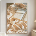 a cozy living room with a white sofa, a wooden side table, and a framed picture of a cup of coffee and an open book on a blanket.