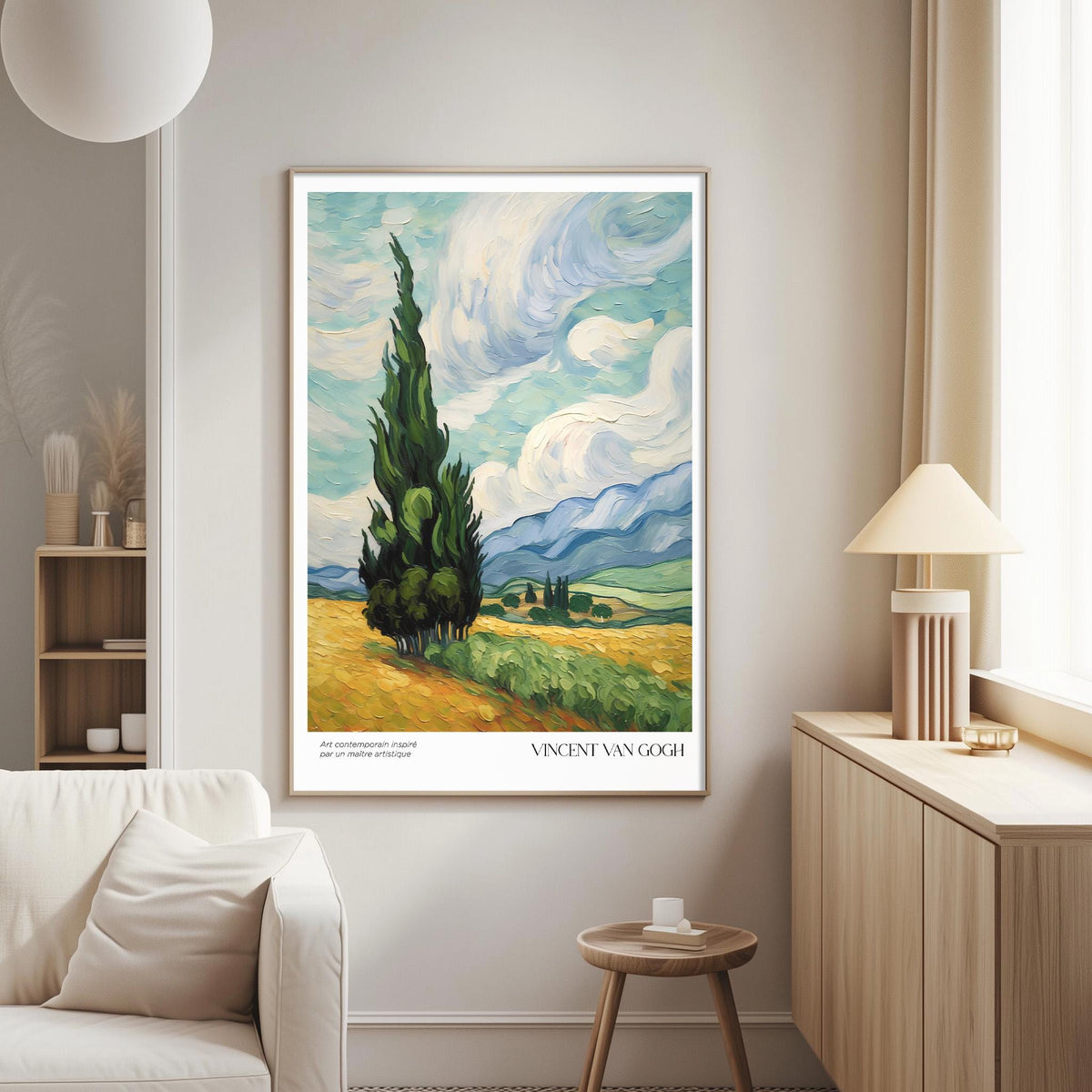 a large painting of a landscape with a tall tree in the foreground, set against a cloudy sky and rolling hills. The painting is hung on a wall in a living room, with a white sofa and a wooden side table nearby.