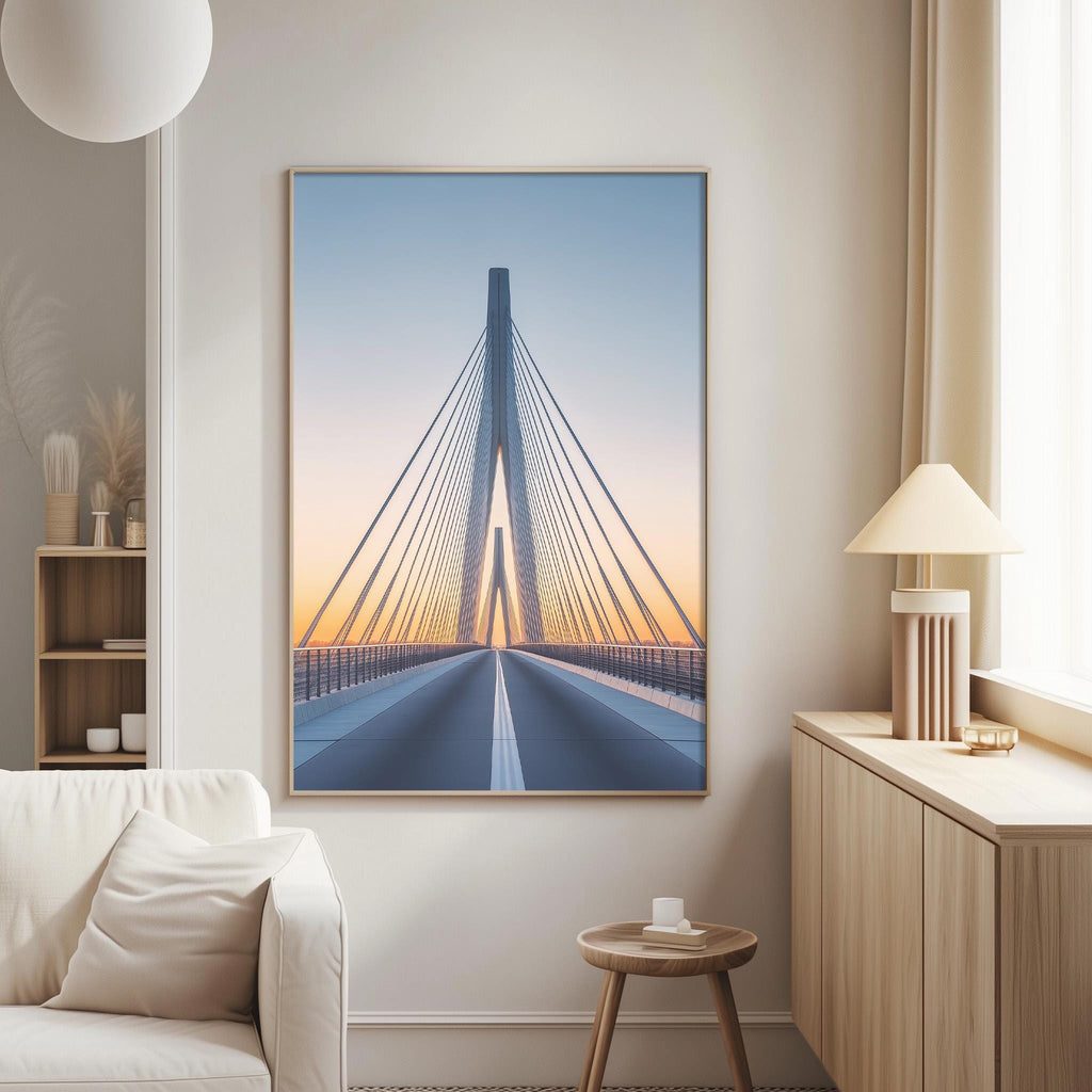 a large framed picture of a bridge with a sunset in the background, hanging on a wall in a living room.
