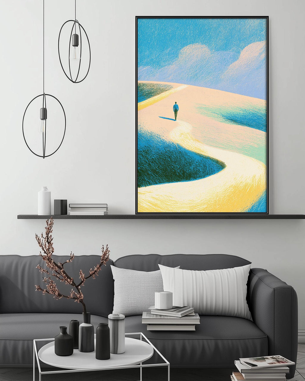 a modern living room with a gray sofa, a coffee table, and a large framed painting of a person walking on a beach.