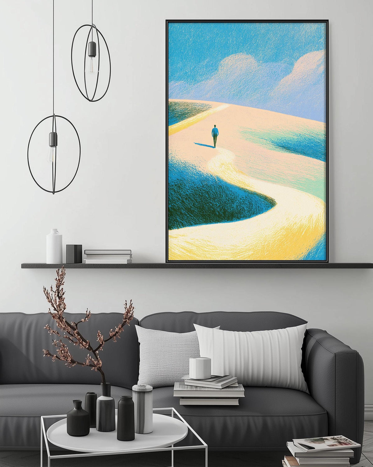 a modern living room with a gray sofa, a coffee table, and a large framed painting of a person walking on a beach.