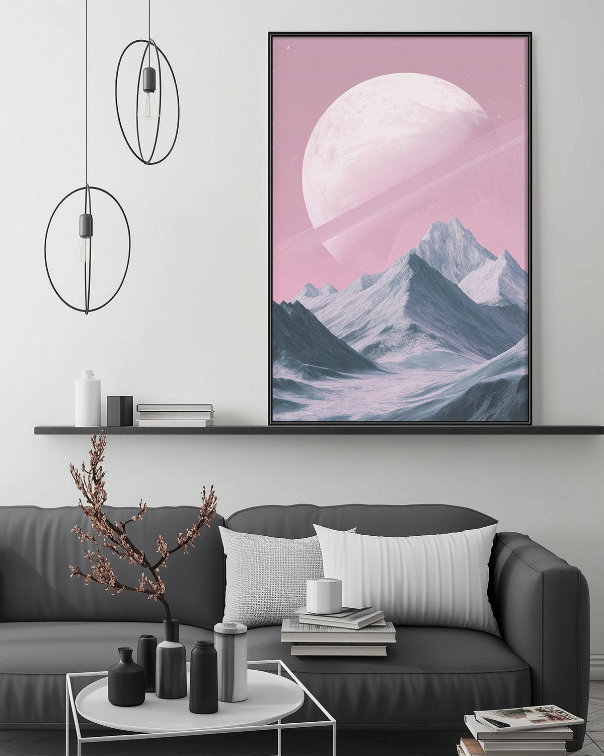 a large, vibrant pink and purple landscape painting hanging on a wall above a gray couch with white pillows. The painting depicts a mountainous scene with a large moon in the sky. The room has a minimalist and modern design, with a white coffee table, a black vase, and a stack of books on the couch.