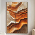 a large abstract painting with a striking color palette of orange and brown, hanging on a white wall in a modern living room setting.