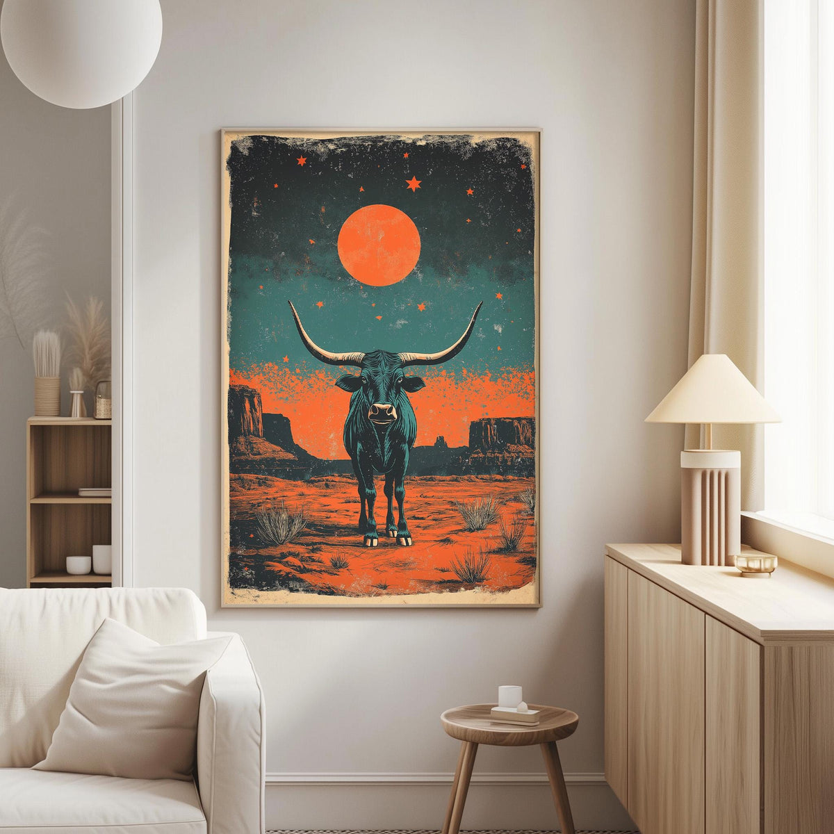 a large framed poster of a bull with horns and a red moon in the night sky, hanging on a wall in a living room.