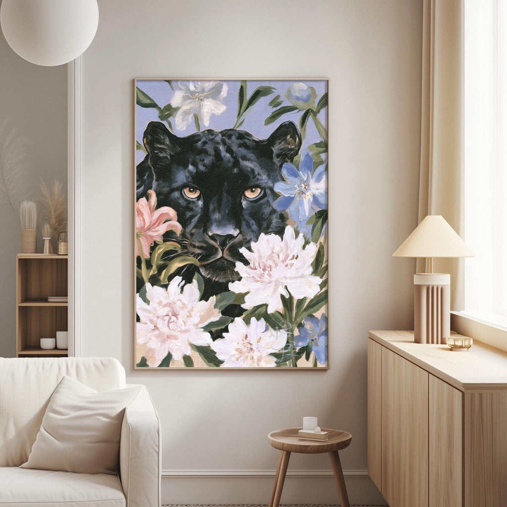 a large framed painting of a black panther surrounded by pink and white flowers, hanging on a wall in a living room setting.