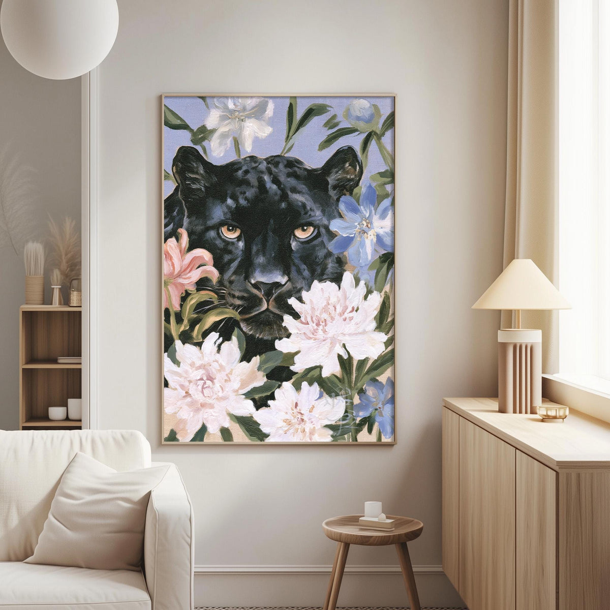 a large framed painting of a black panther surrounded by pink and white flowers, hanging on a wall in a living room setting.
