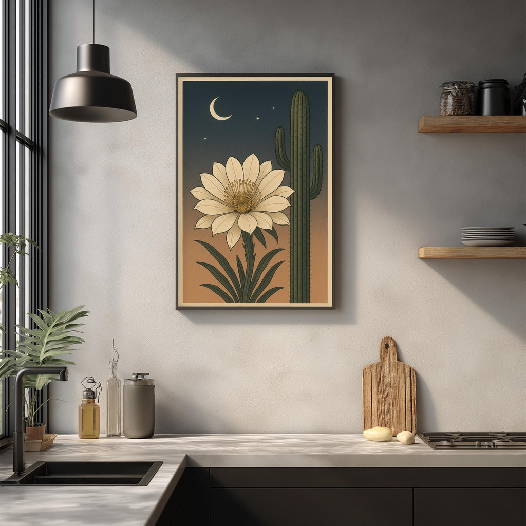 a framed illustration of a cactus with a large white flower on the wall above a kitchen counter.