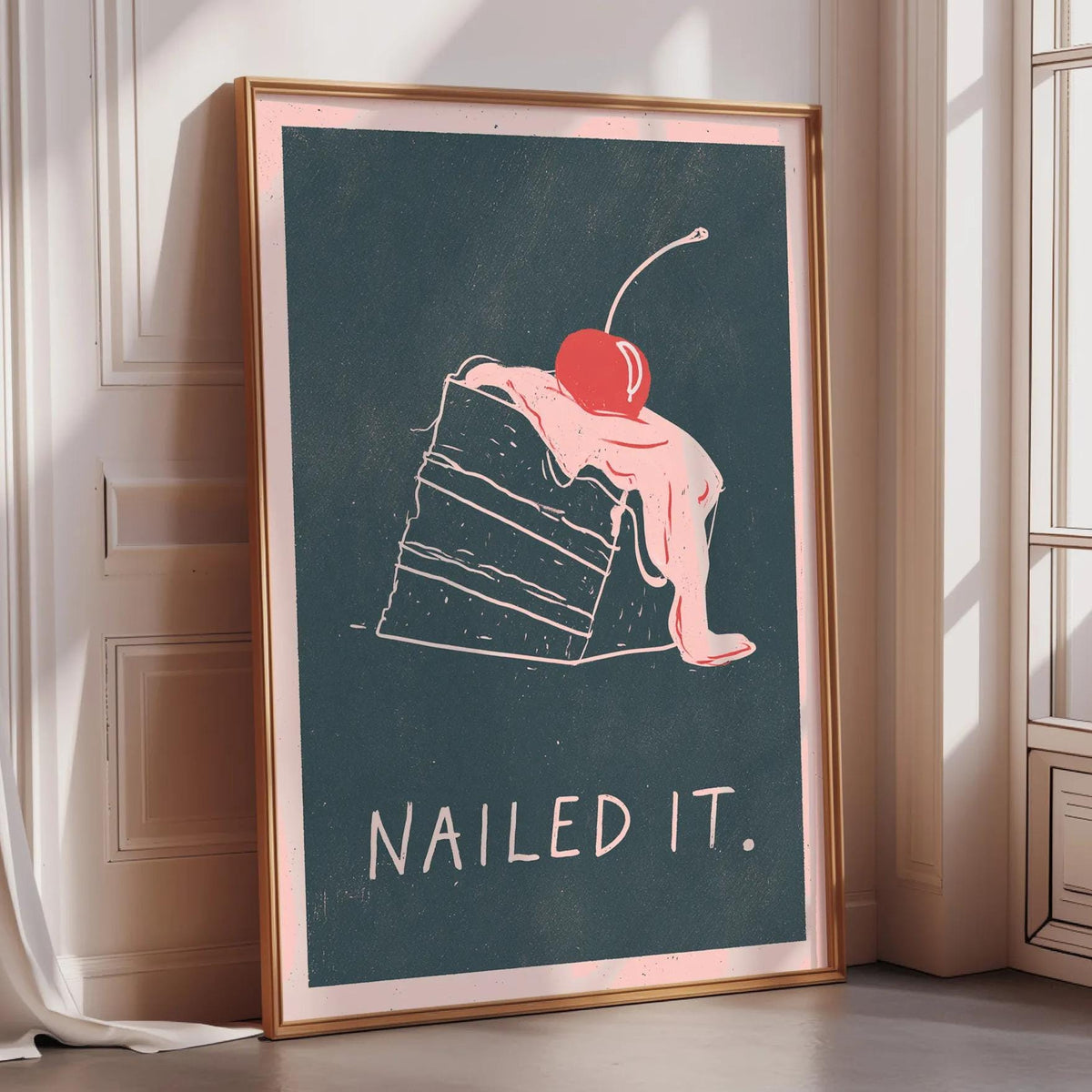 A framed poster with a drawing of a slice of cake and the text "Nailed it."