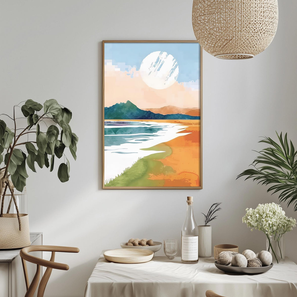 a serene landscape with a large white circle in the sky, a calm body of water, and a mountain range in the distance. The scene is framed and hung on a wall above a dining table, which is set with various items such as a bottle, a bowl, and a vase. The table is surrounded by chairs, and there are potted plants and other decorative elements in the room, creating a cozy and inviting atmosphere.
