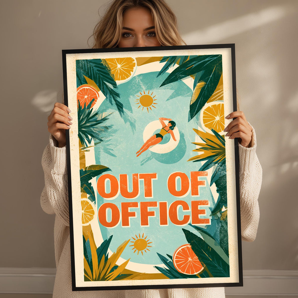 A woman holding a framed poster with a tropical beach scene and the text "OUT OF OFFICE" on it.