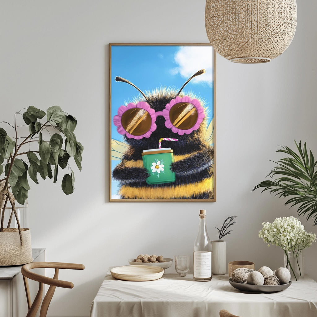 a framed picture of a bee wearing sunglasses and holding a drink, hanging on a wall above a dining table with various items on it.