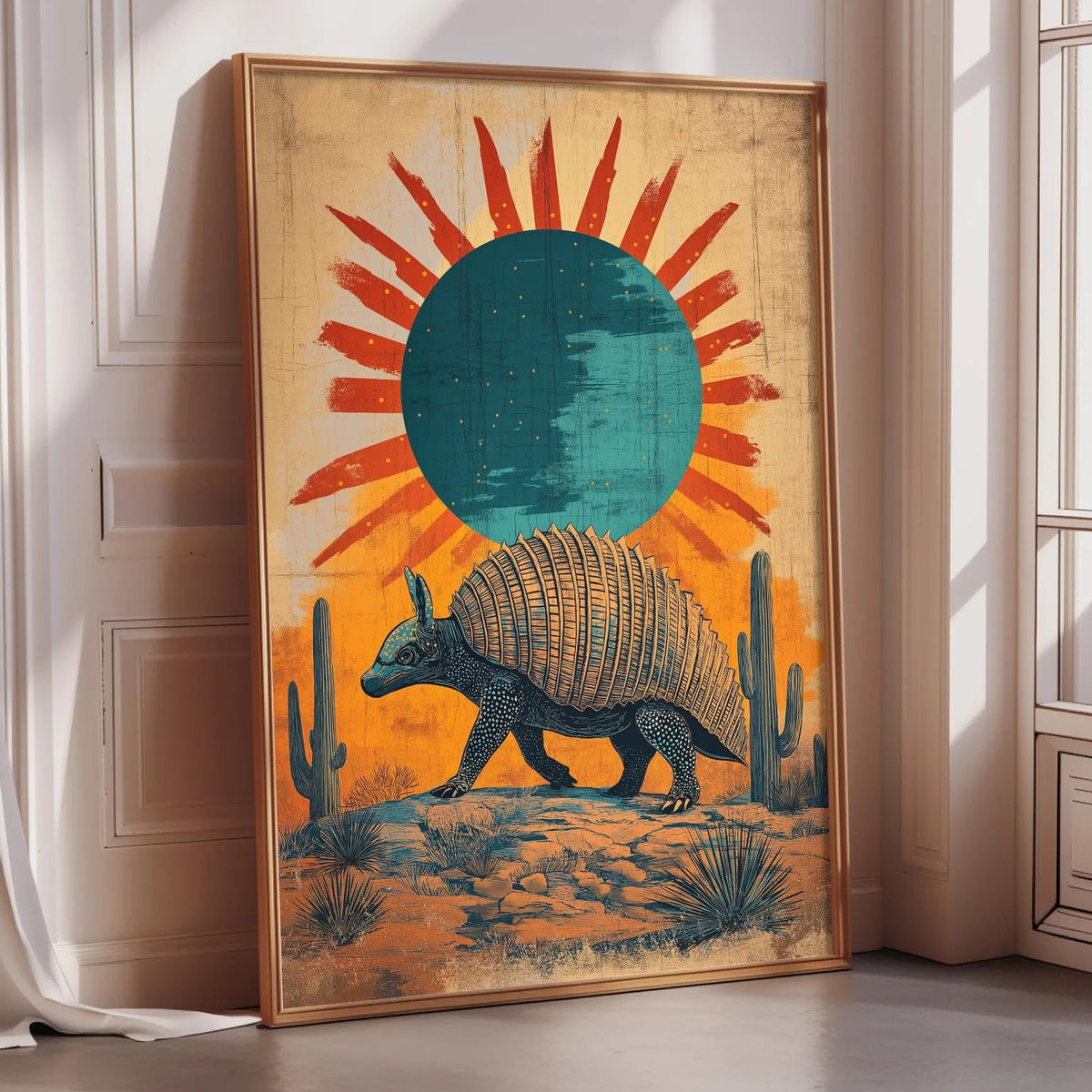 a large framed artwork depicting an armadillo in a desert landscape with a sun-like design in the background.
