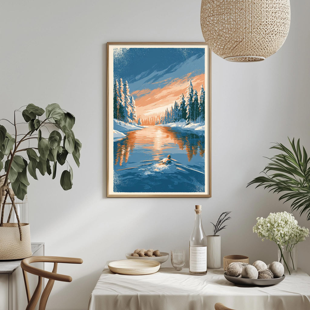 a serene winter landscape with a river reflecting the sky and trees covered in snow. The scene is framed and hung on a wall, with a dining table and chairs in the foreground. The table is set with various items, including a bottle, a bowl, and a vase, creating a cozy and inviting atmosphere.