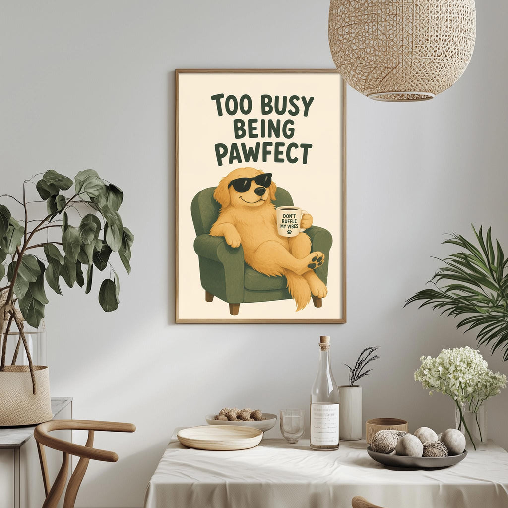 a framed poster with a cartoon dog sitting in a chair, holding a cup and a sign that says "Too Busy Being Pawfect". The poster is hanging on a wall above a dining table with various items on it, such as a bottle, a bowl, and a vase.